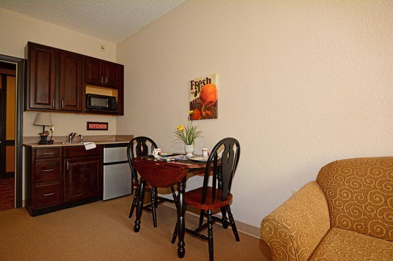 A cozy kitchenette with a small dining area and basic appliances.