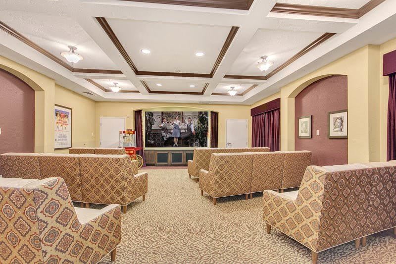 A luxurious home theater with comfortable seating and a large screen.