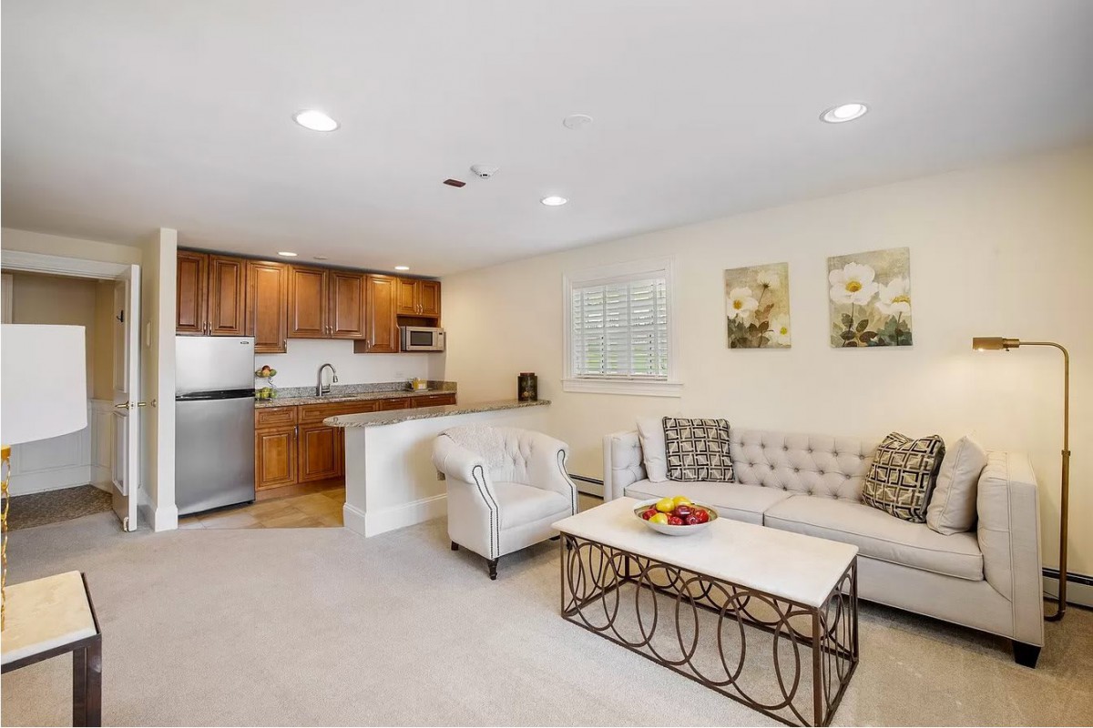 A cozy open floor plan living room and kitchen with comfortable seating and modern decor.