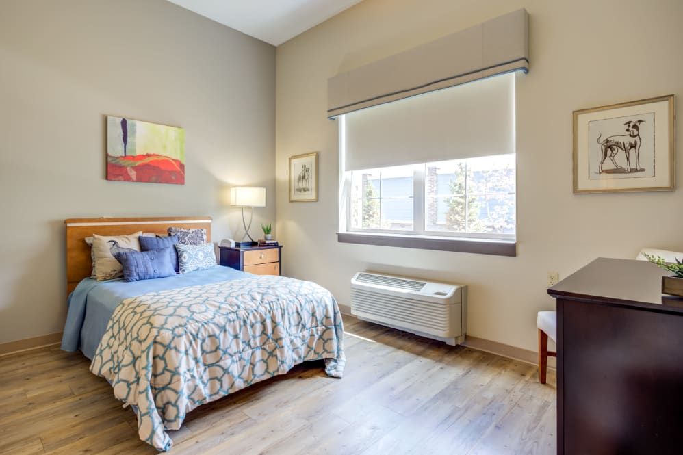 A modern bedroom with a comfortable bed, stylish furniture, and natural lighting.