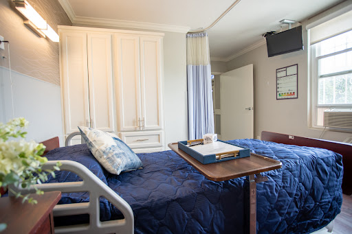 A well-equipped hospital patient room featuring a bed, medical furnishings, and a comfortable environment.