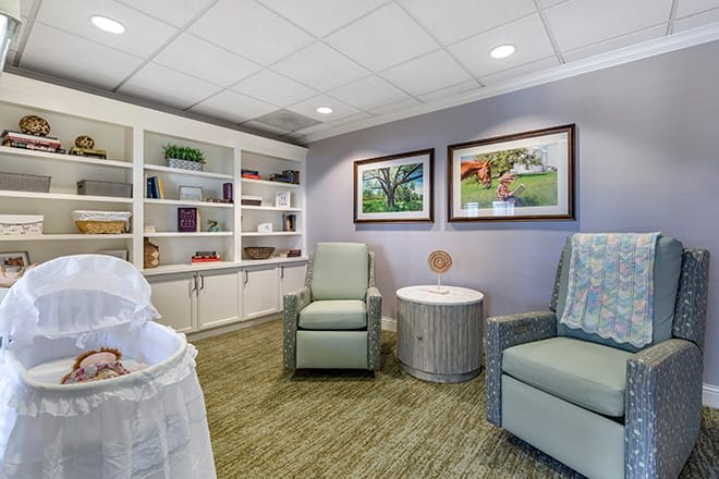 A comfortable waiting room with seating and art-adorned walls.