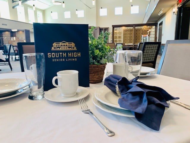Elegant table setting with a menu at South High House Cafe.