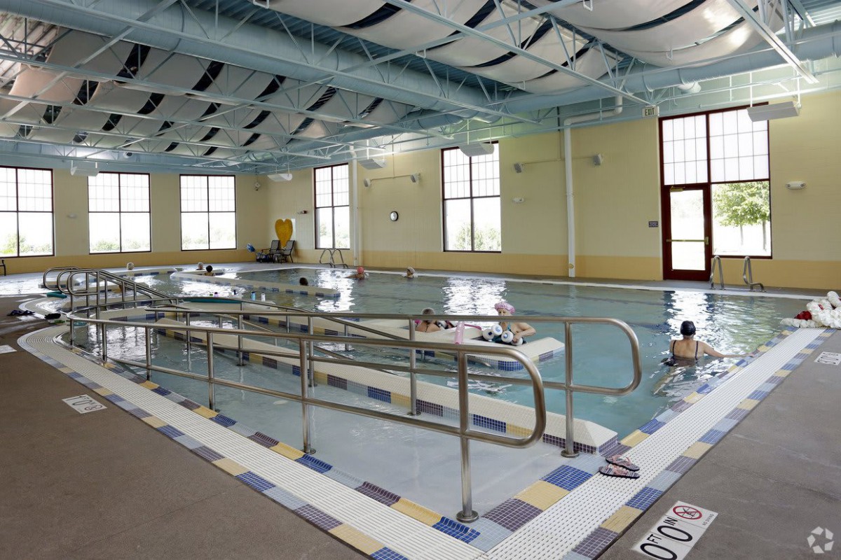 An indoor swimming pool designed for rehabilitation, equipped with accessibility features.