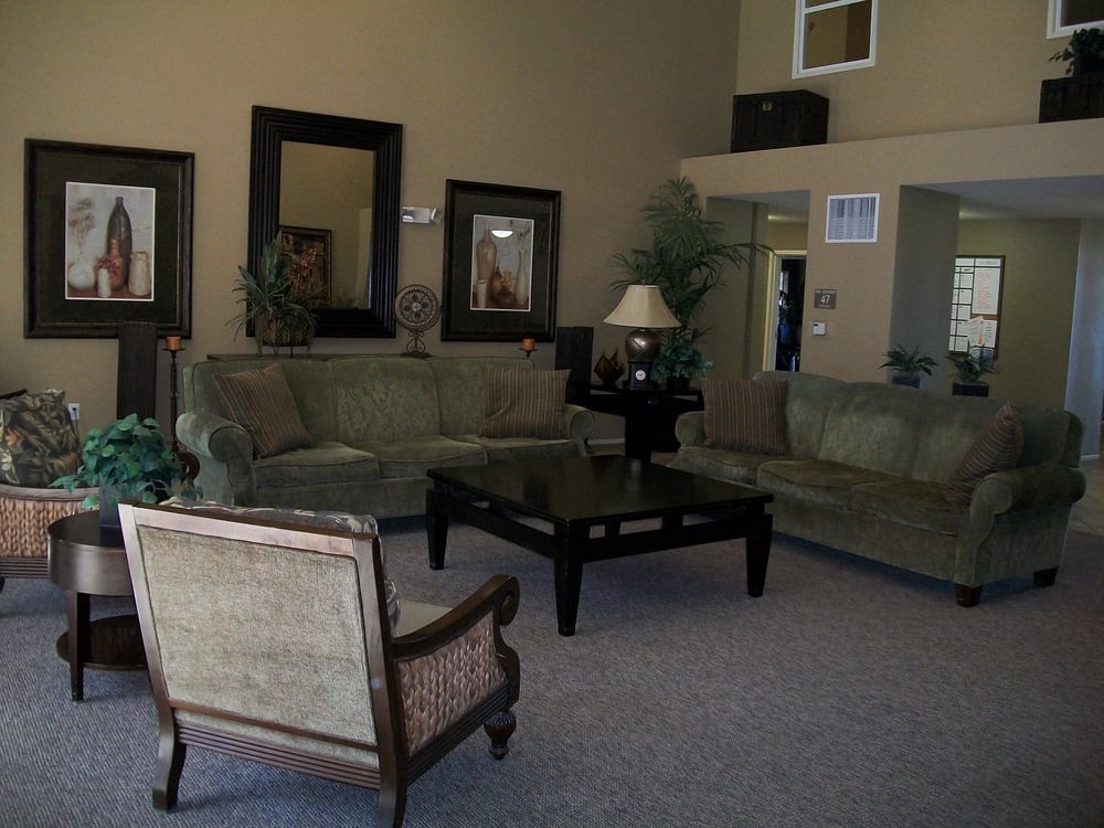 A cozy living room with sofas, an armchair, and a coffee table.