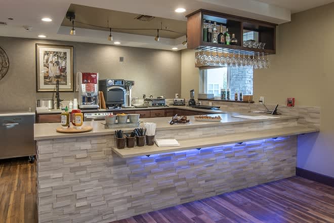 A modern coffee shop counter with various drinks and equipment.