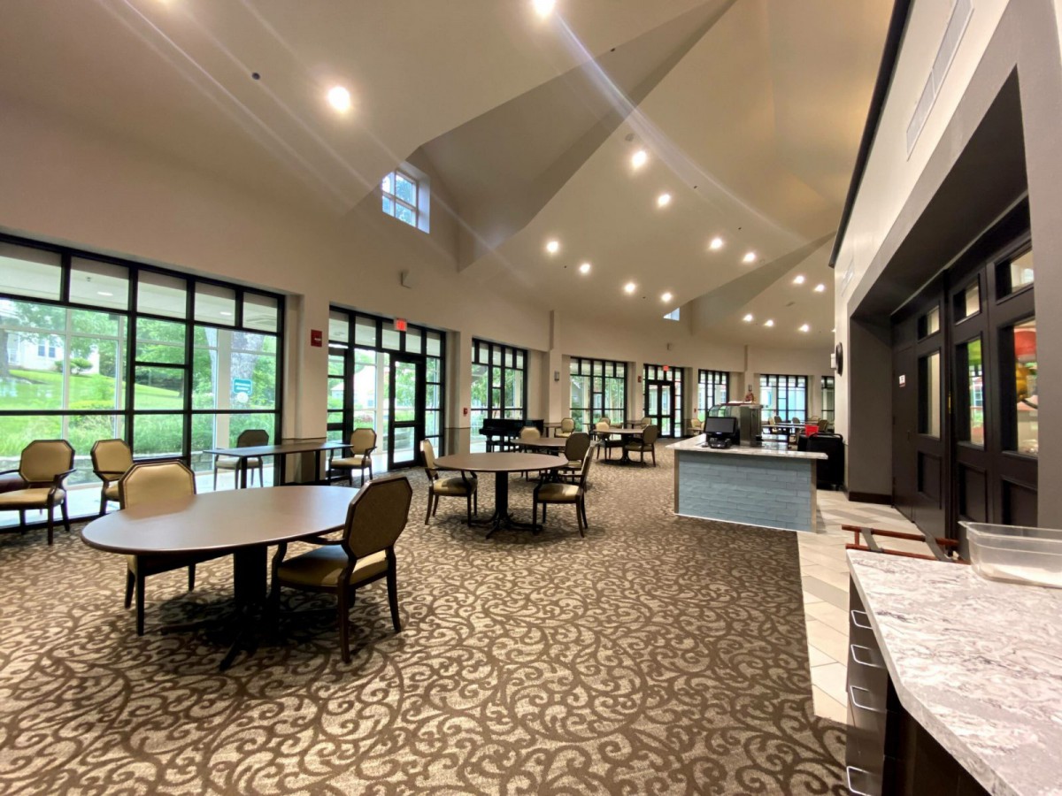 A spacious lounge with modern furniture and large windows providing ample natural light.