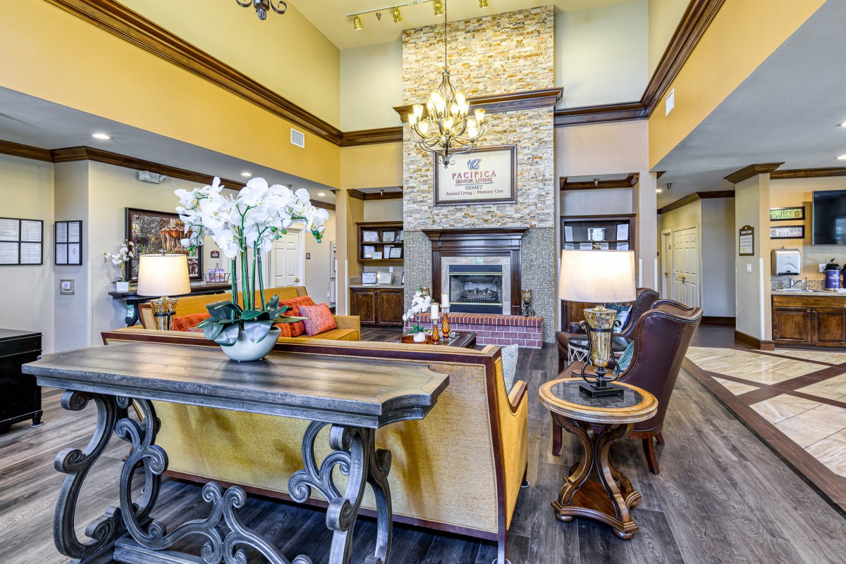 A cozy living room featuring a stone fireplace and elegant furnishings.