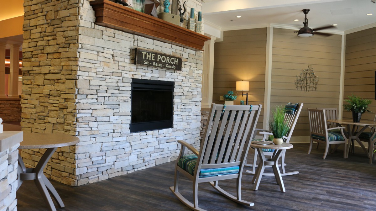 A cozy living room with a fireplace and rocking chairs.