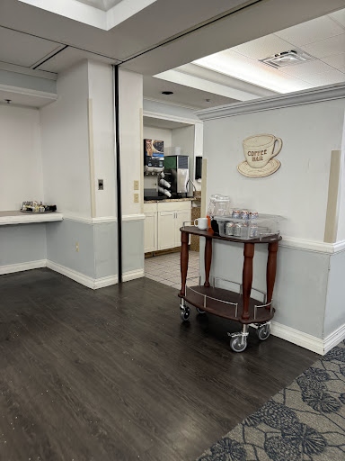A view of a stylish reception area featuring a wooden cart and a welcoming ambiance.