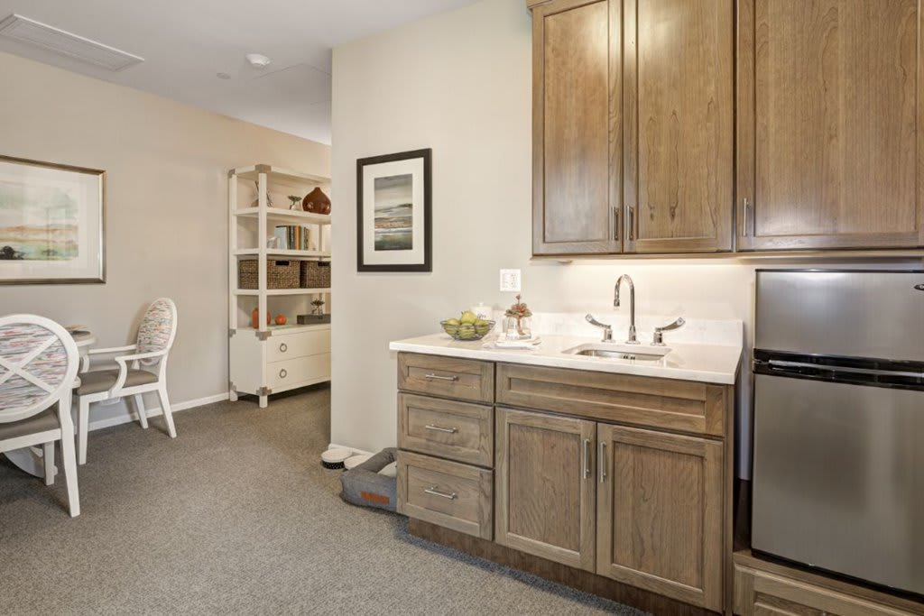 A cozy kitchen area featuring wooden cabinets, a sink, and stylish decor.