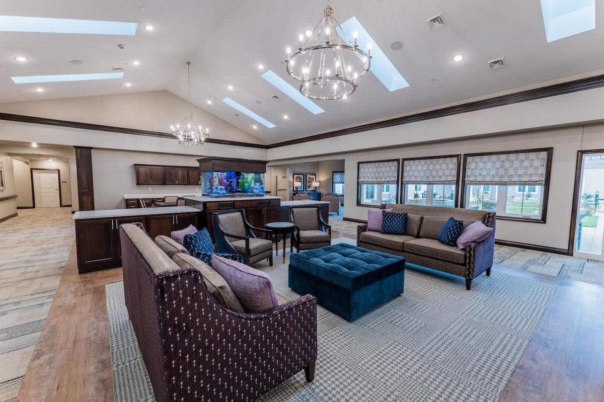 Spacious living room with elegant chandeliers and stylish furniture.