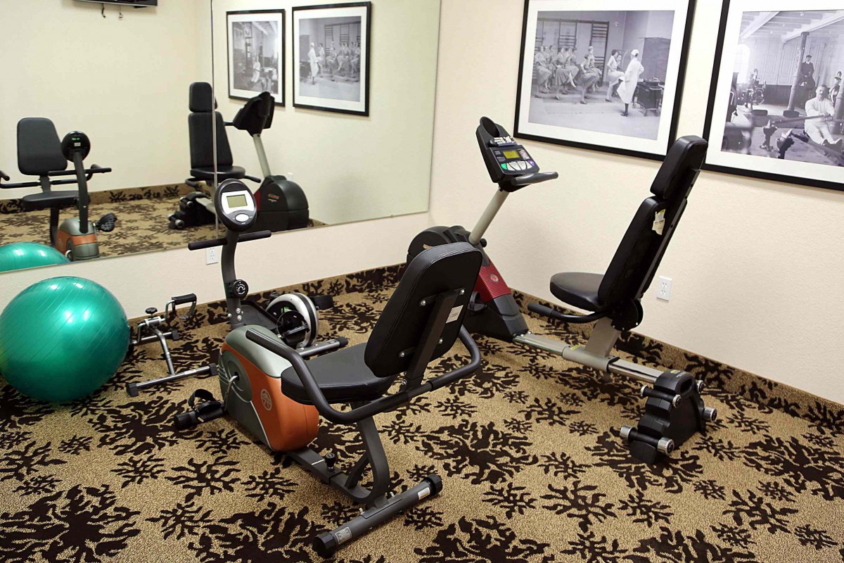A small gym with an exercise bike and other fitness equipment.