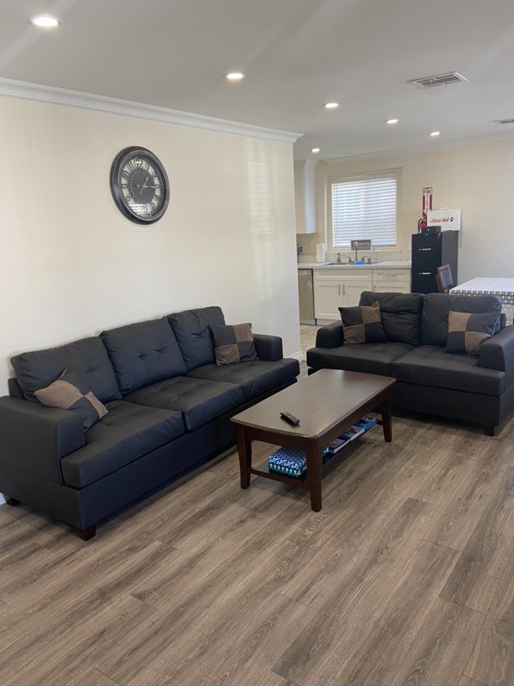 A modern living room with a comfortable sofa set, a coffee table, and wood flooring.