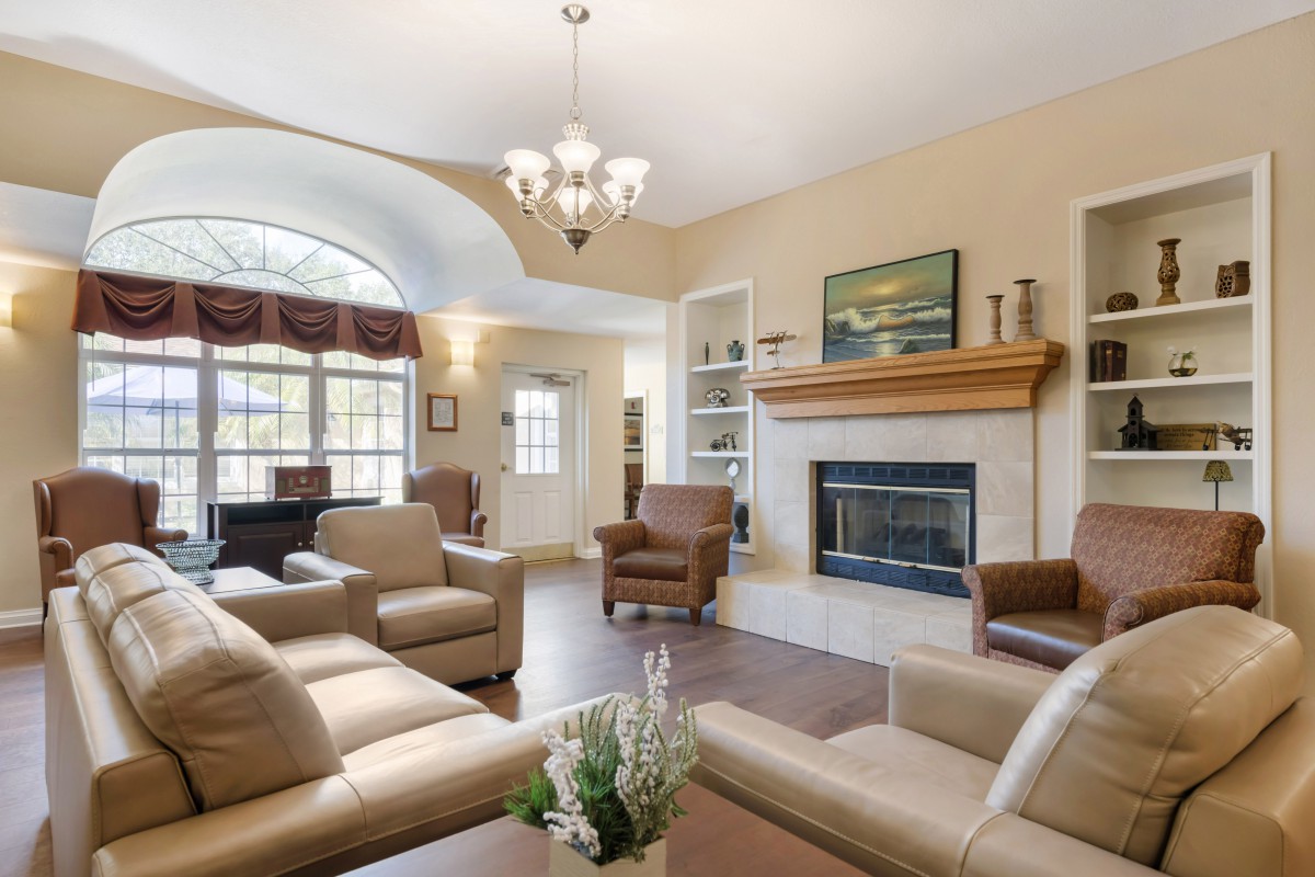 A cozy living room featuring comfortable sofas, a fireplace, and elegant decor.