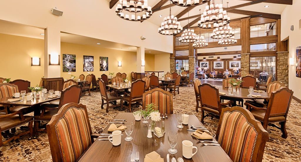Elegant dining area with warm lighting and neatly arranged tables.