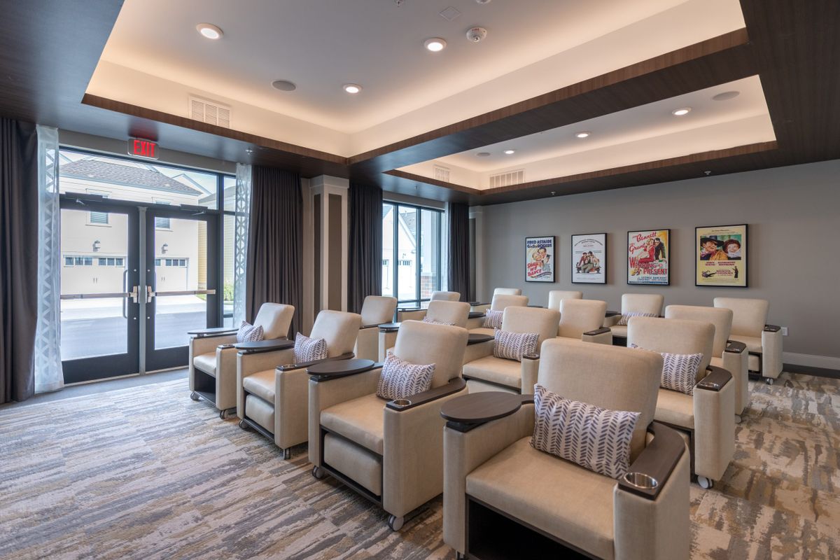 A modern and luxurious theater room with comfortable seating arrangements.