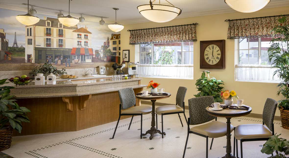 A cozy cafe with tables and chairs, a counter area, and decorative elements including a large clock on the wall.