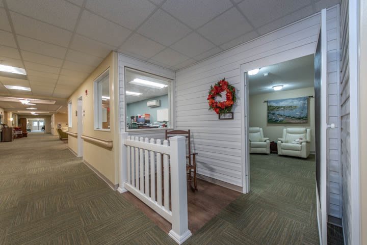 A welcoming office interior featuring a reception area and waiting room with comfortable seating and decorative elements.