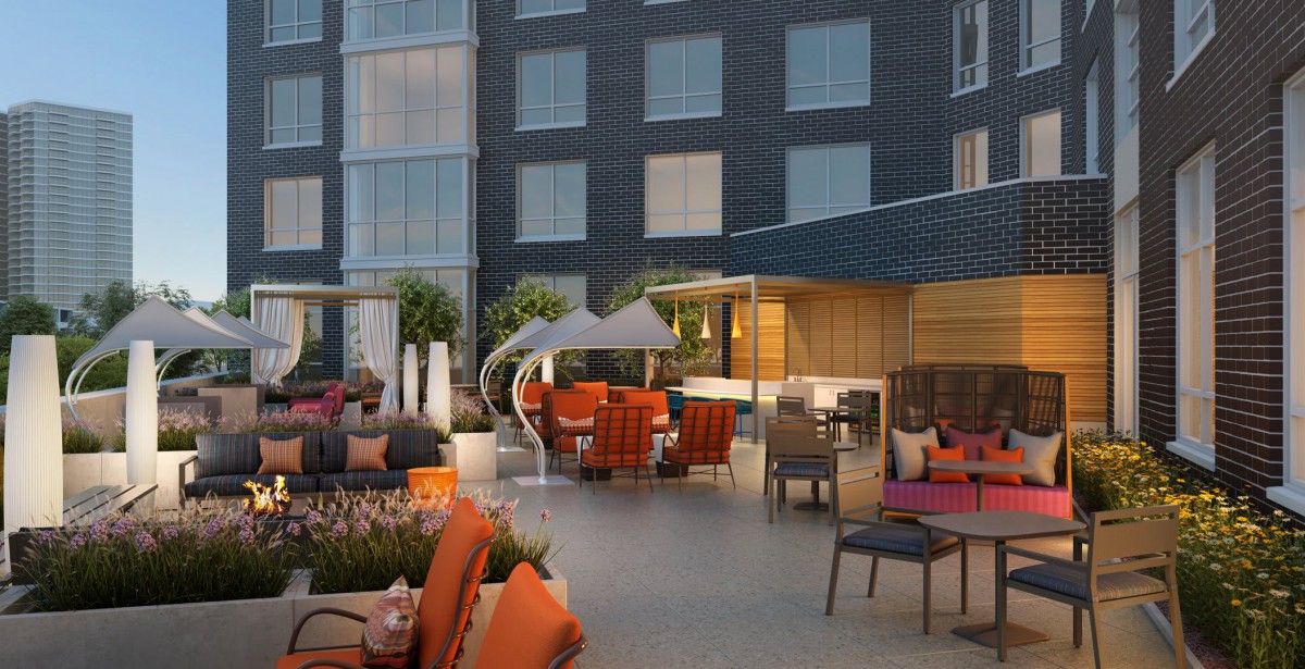 Modern hotel patio with colorful seating and stylish decor.