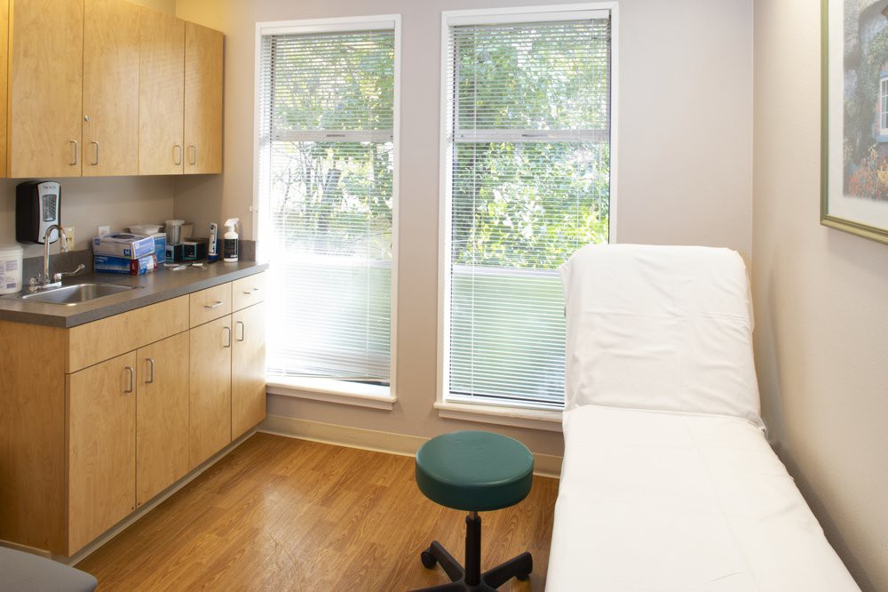 A clean and well-organized examination room in a medical clinic.