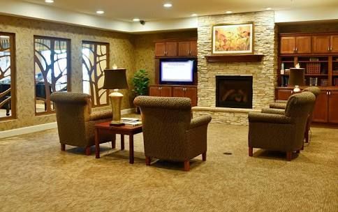 A cozy living room with a fireplace and comfortable seating.