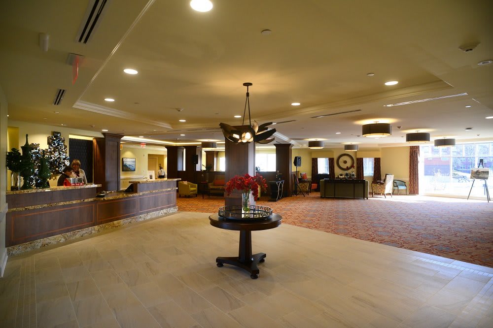 A spacious hotel lobby with a reception desk and elegant decor.