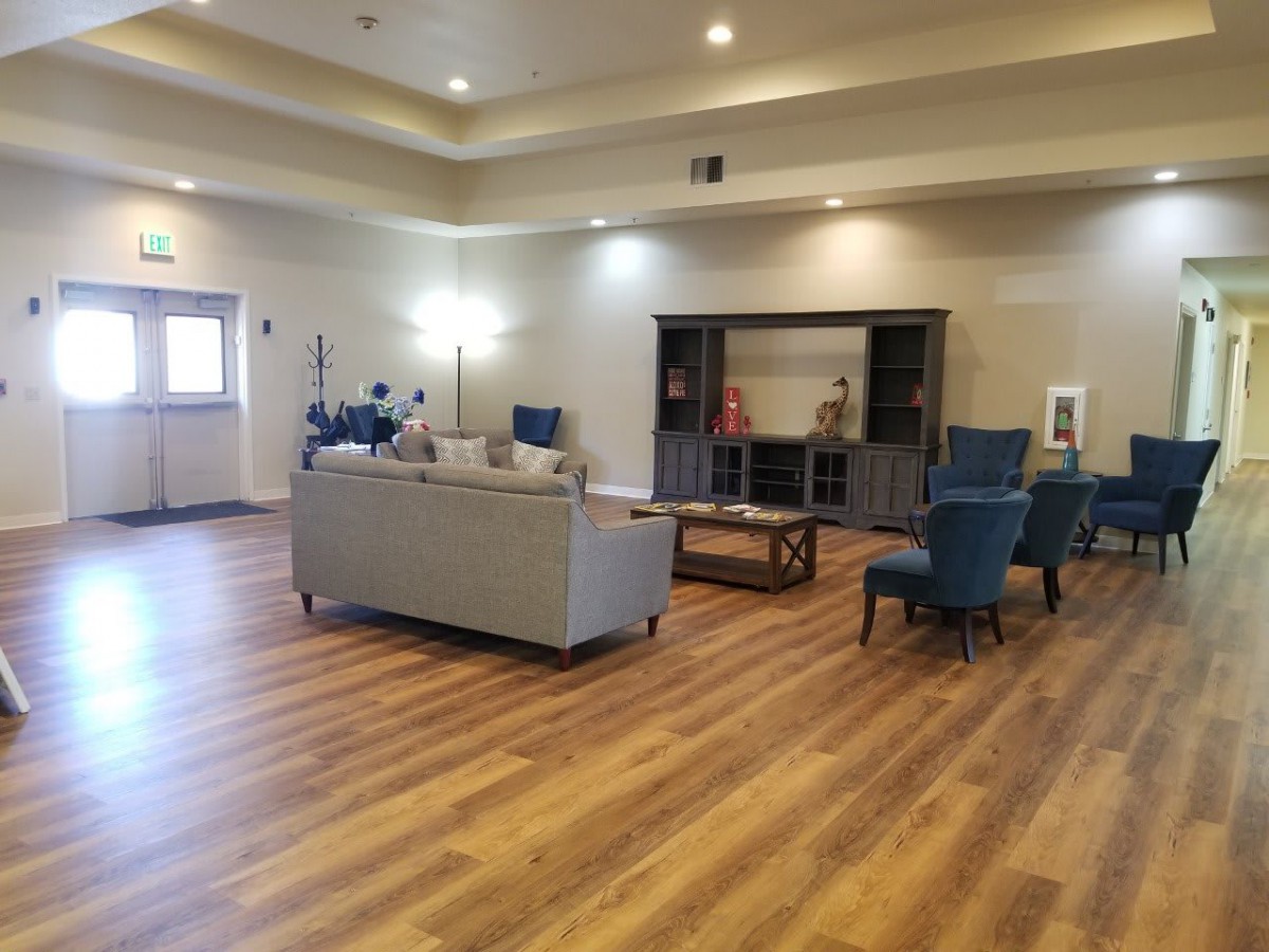 Spacious living room with modern furniture and hardwood flooring.