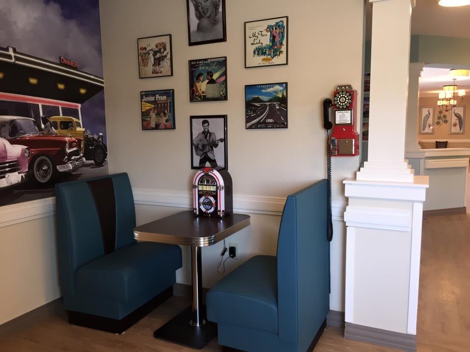 A cozy retro diner booth with a classic jukebox and vintage decor.