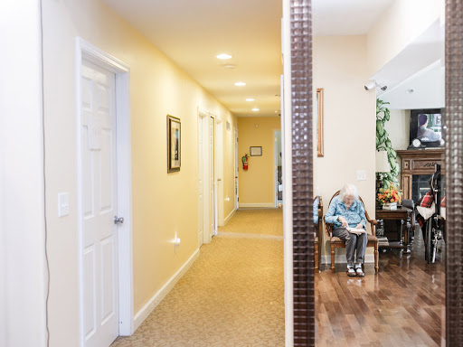 A spacious interior hallway leading to various rooms, showcasing a cozy living area with furniture.