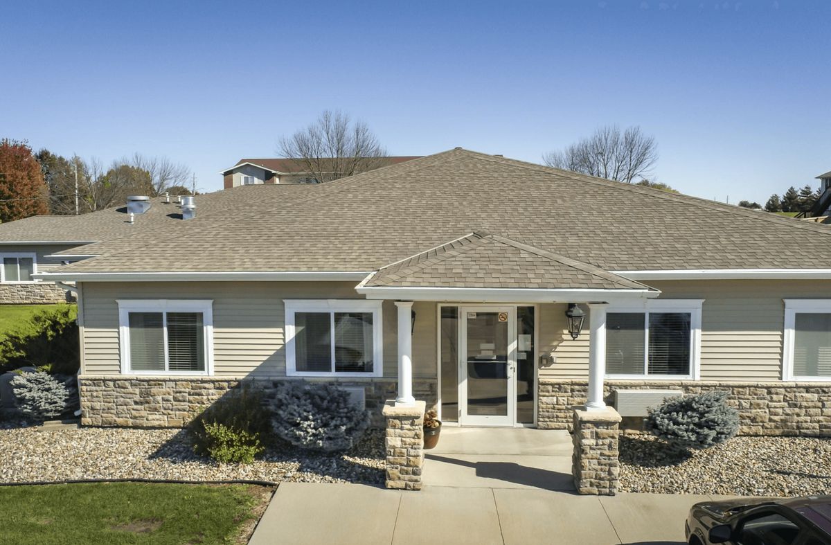 A well-maintained residential house with a stone pathway and front porch.