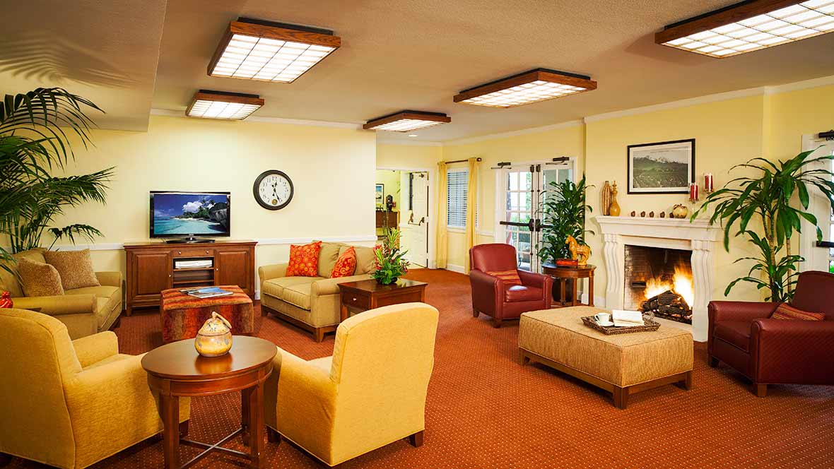 A cozy living room with comfortable seating and warm lighting.