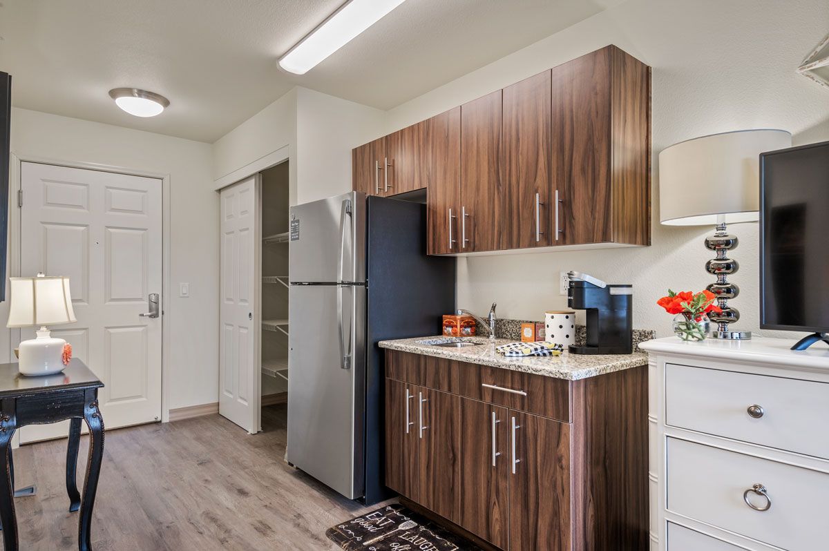 A modern kitchen with wood cabinets and stainless steel appliances.