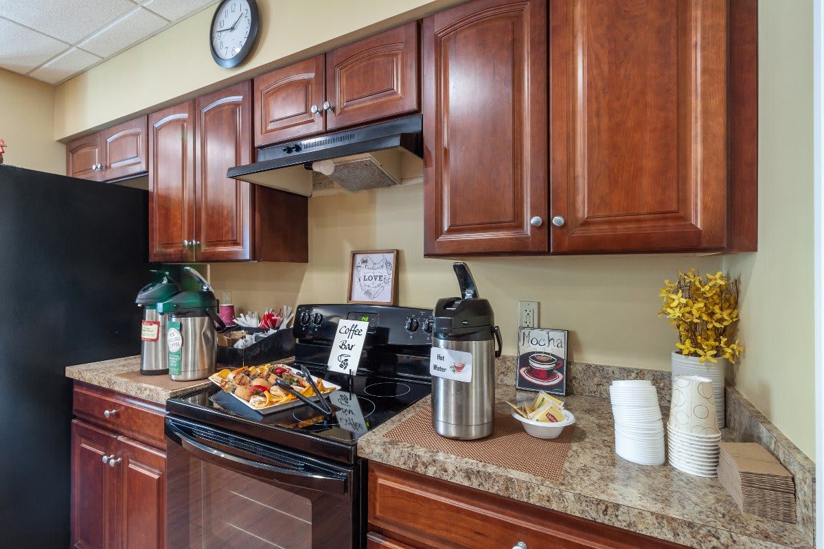 A cozy kitchen setup with coffee dispensers and snacks on the countertop.