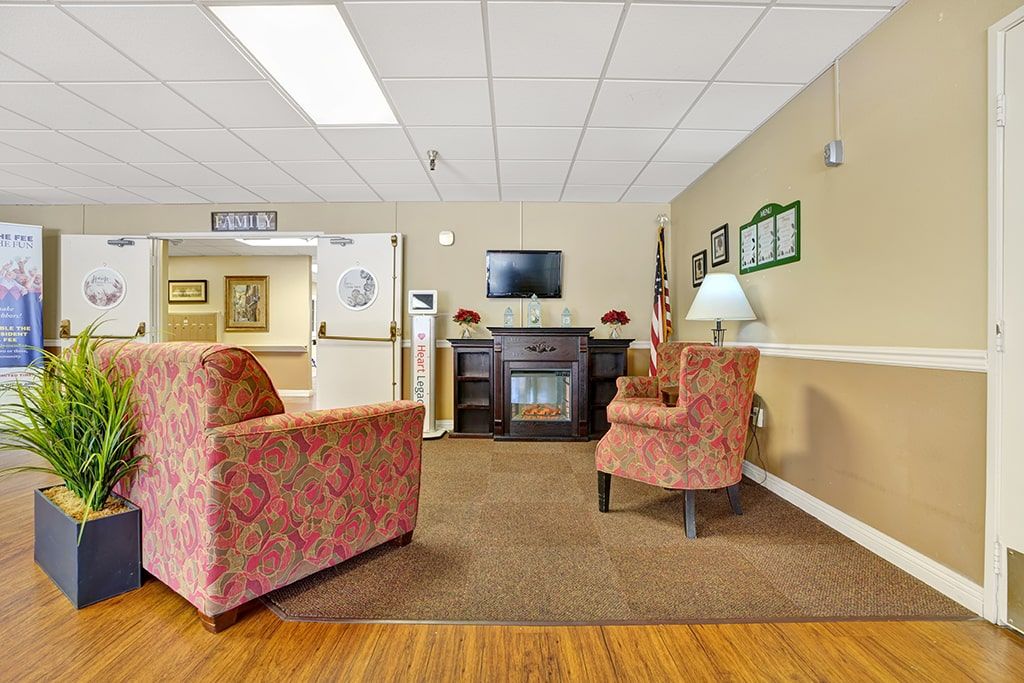 A cozy waiting room with comfortable chairs and a television.