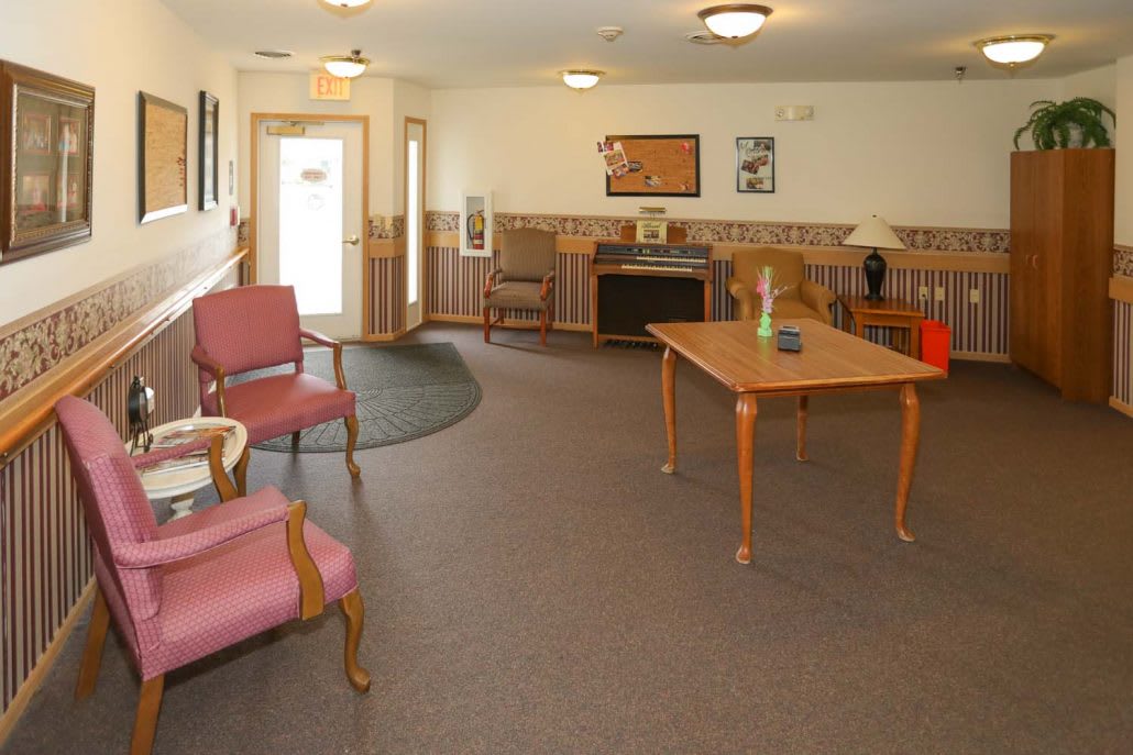 A cozy lobby with comfortable seating and a table, creating a welcoming waiting area.