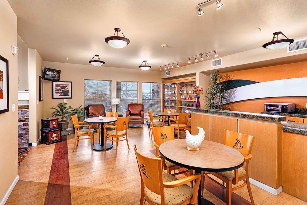 A cozy restaurant interior featuring wooden tables and chairs, with warm lighting and tasteful decor.
