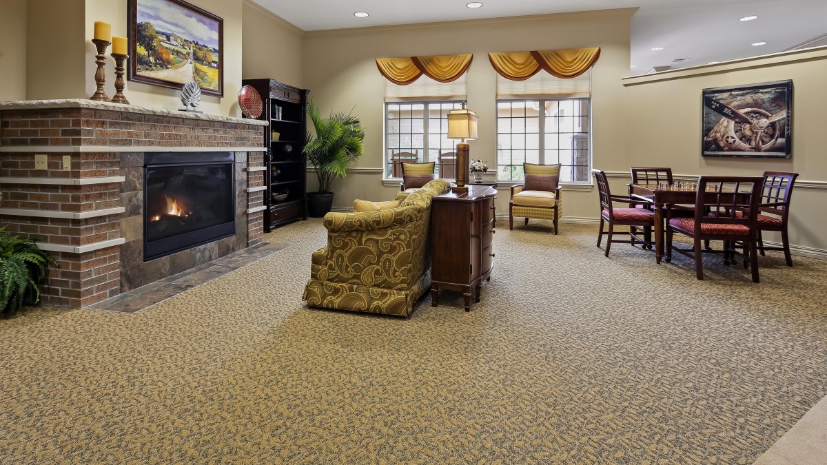 A cozy living room with a fireplace and elegant furniture.