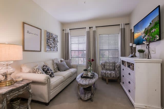 A cozy living room with a sofa, armchair, and stylish decor.