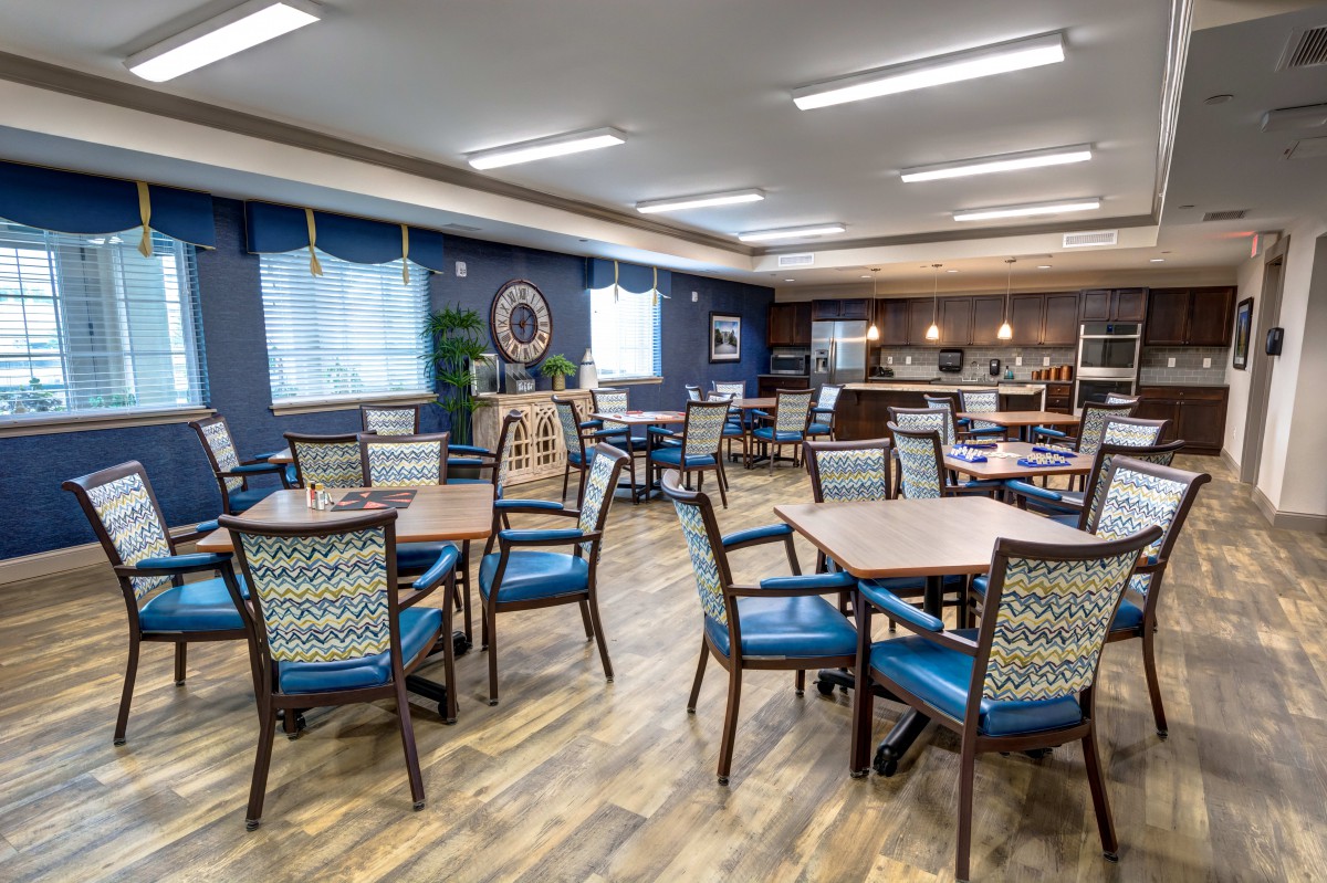 A modern dining area with tables and chairs, featuring a spacious and well-lit interior.