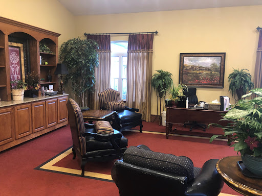 A cozy office space featuring comfortable seating and decorative plants.