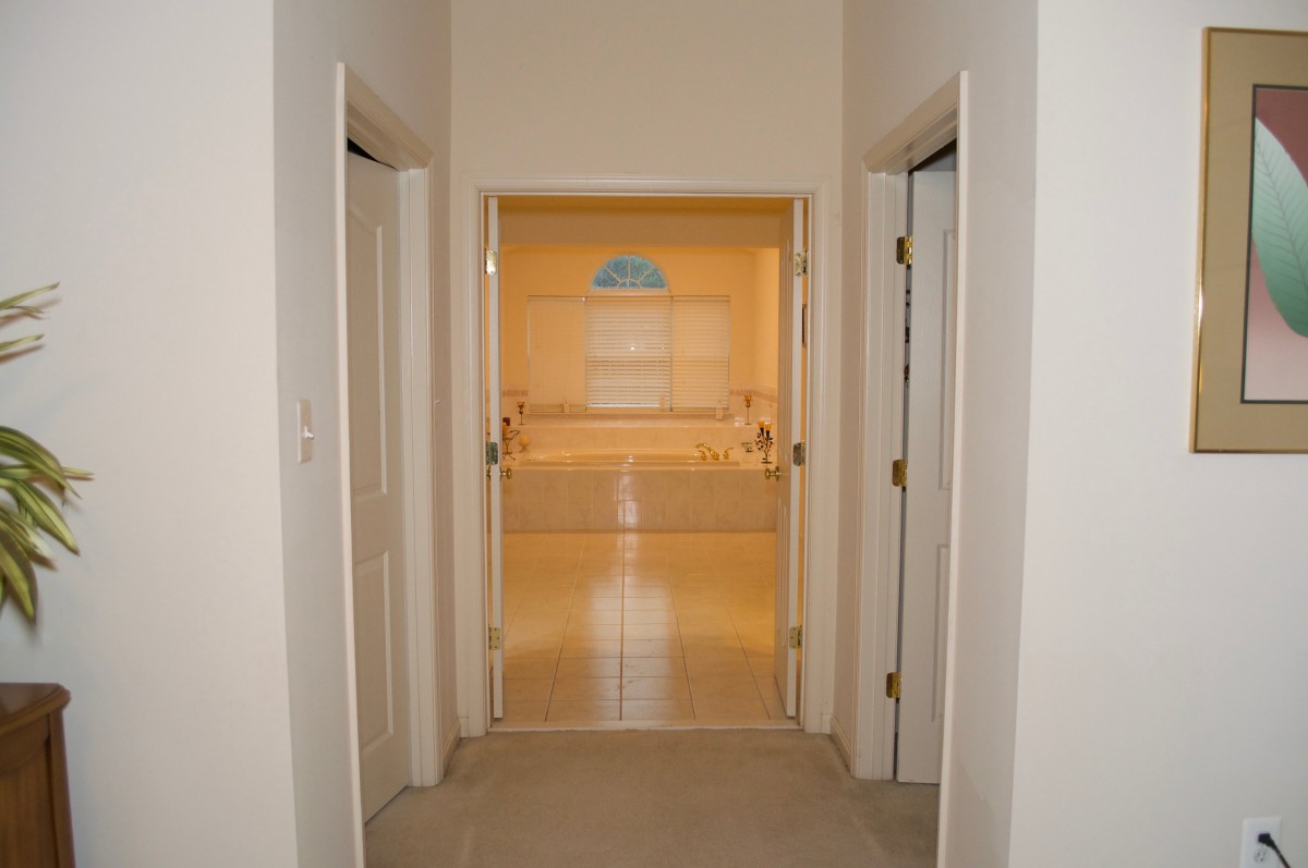 View of a hallway with doors leading to different rooms.