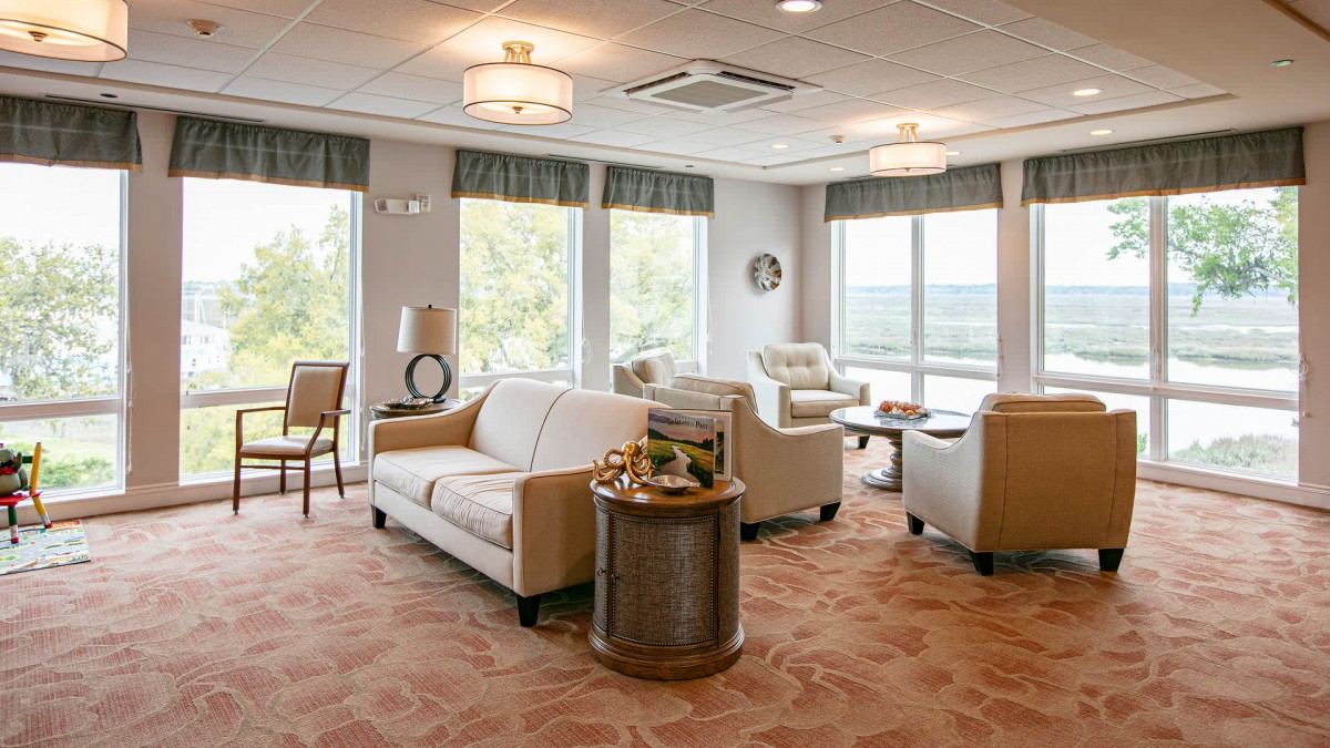 A bright and relaxing lounge area with comfortable seating and large windows.