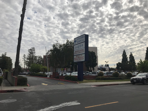 A view of an urban area with a cloudy sky and street signage.