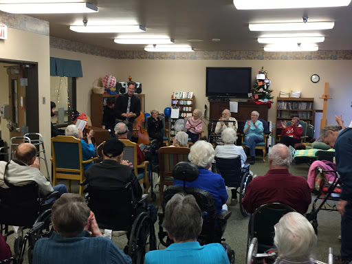 A lively gathering at a community center featuring a performance for the elderly residents.
