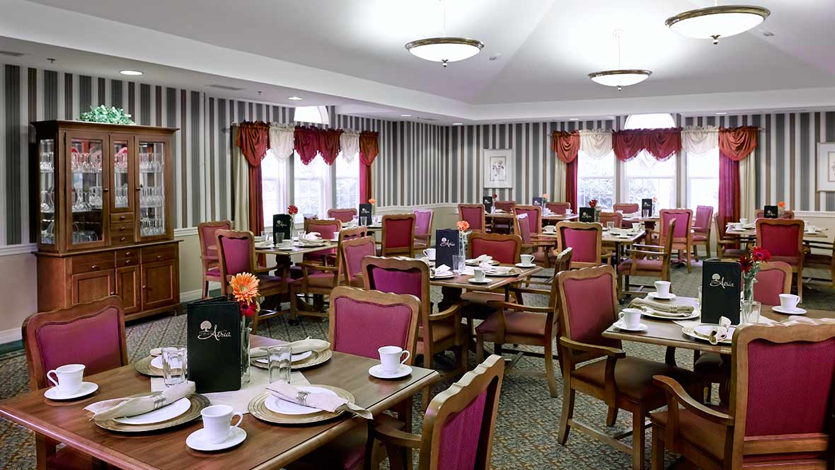 Elegant dining room with neatly arranged tables and chairs.