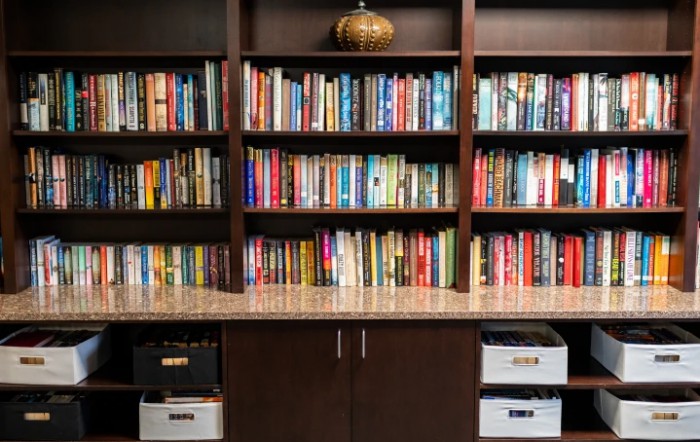 A neatly organized bookshelf filled with a variety of books.
