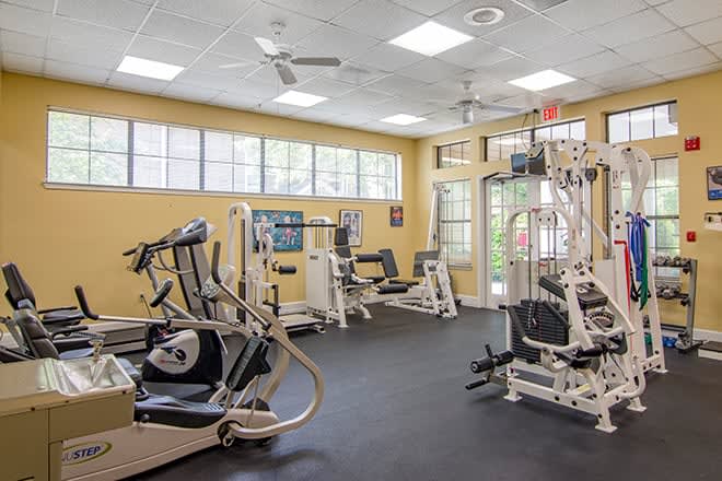 A well-equipped gym with various exercise machines and fitness equipment.