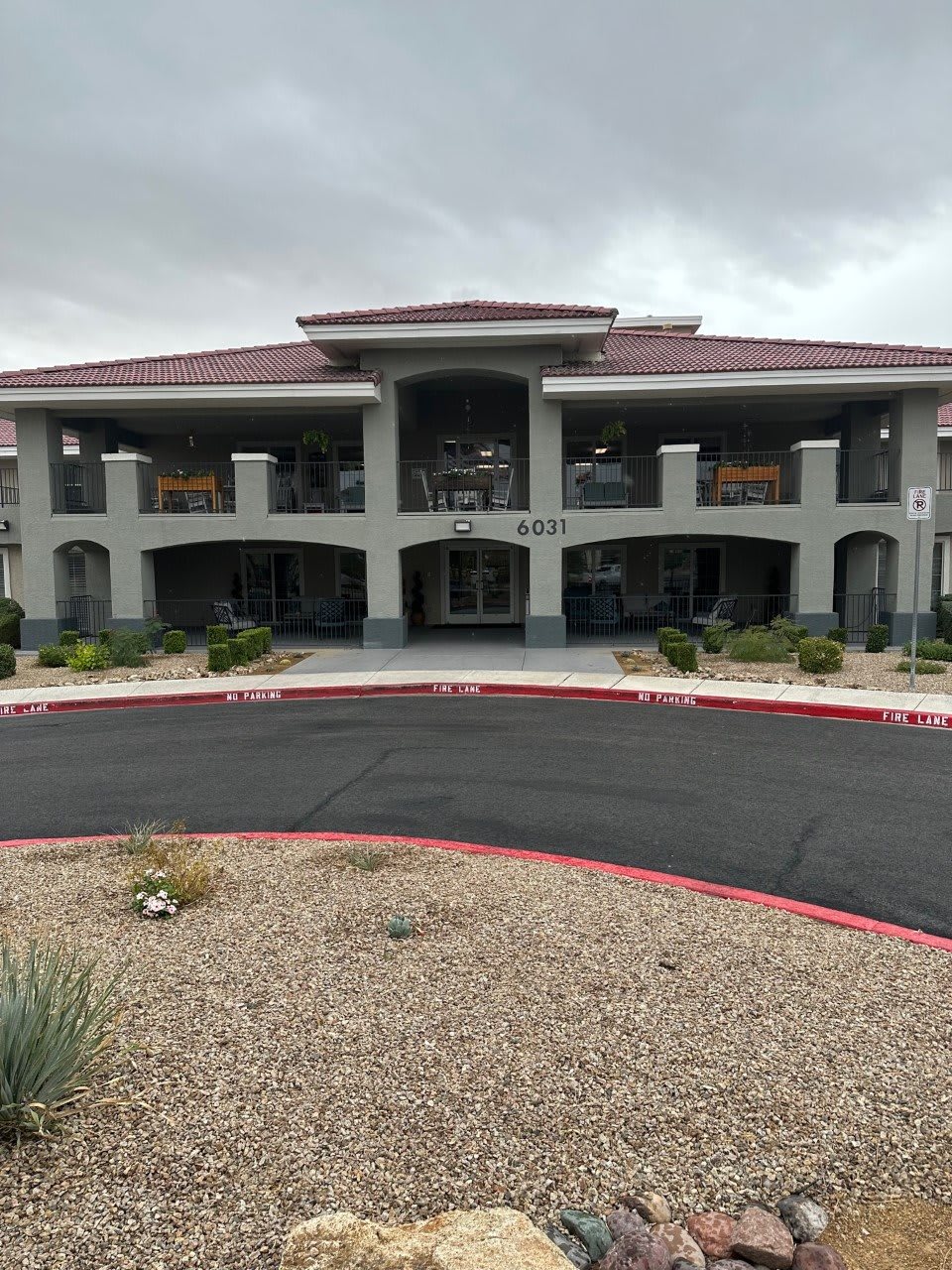 A two-story hotel building with a landscaped entrance.