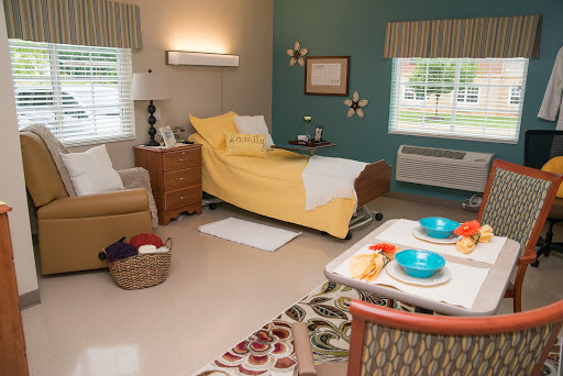 A cozy hospital room featuring yellow bedding and comfortable furnishings.